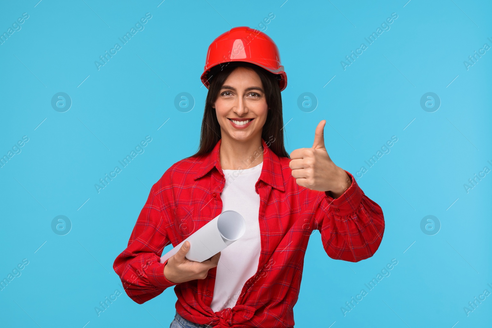 Photo of Architect in hard hat with draft on light blue background