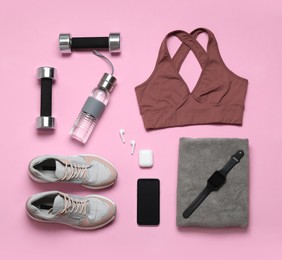 Photo of Flat lay composition with sports equipment on pink background