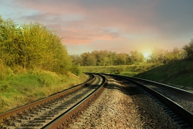 Photo of Railway lines in countryside on sunny day. Train journey