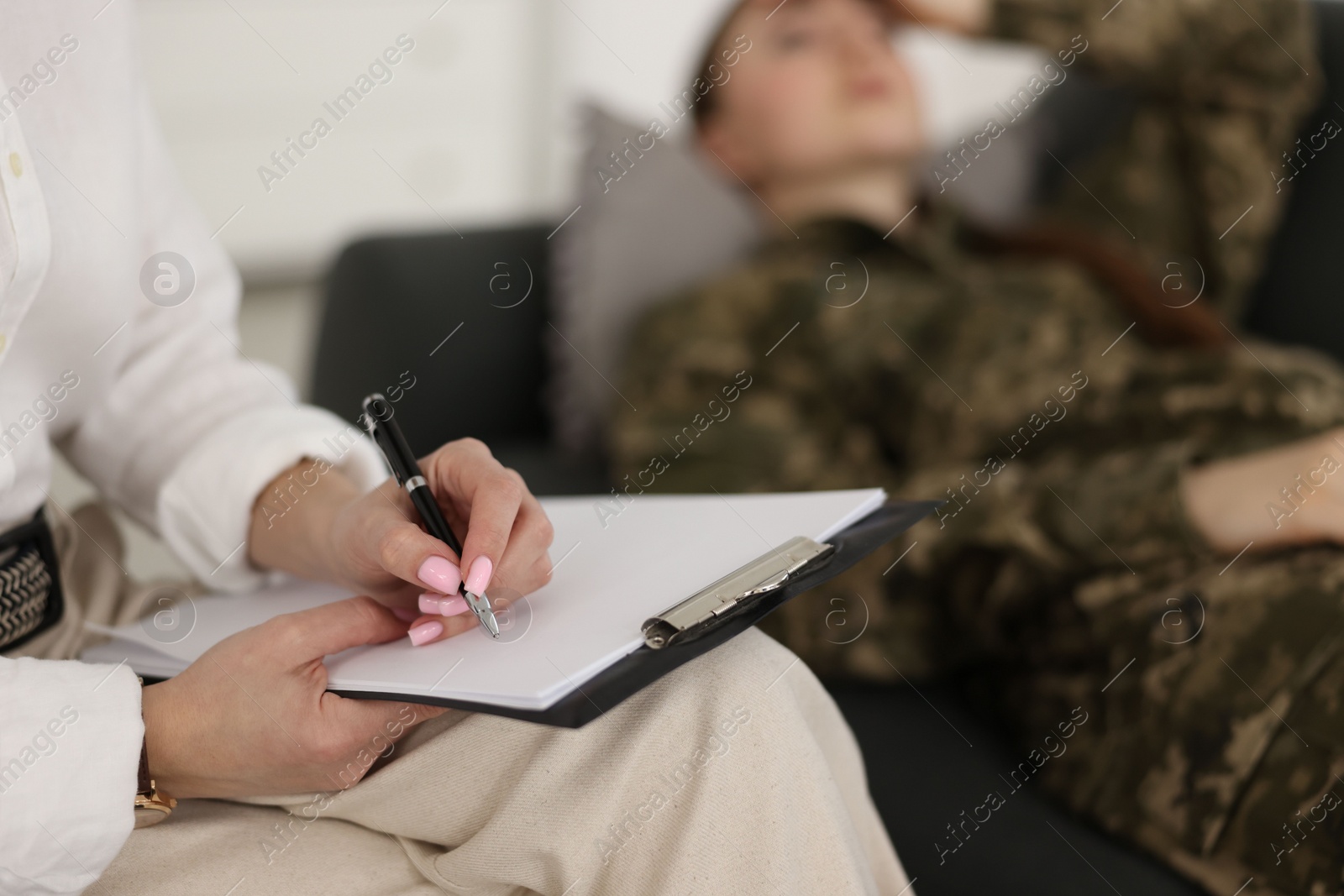 Photo of Psychotherapist working with military woman in office, closeup