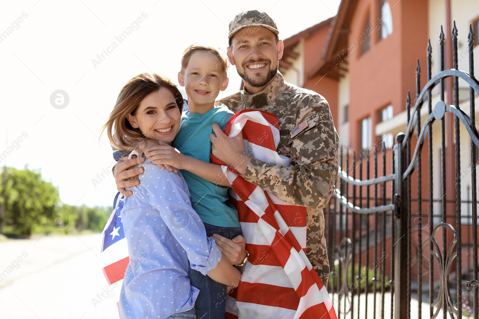 Photo of American soldier with family outdoors. Military service