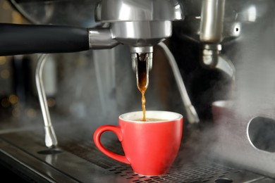 Photo of Making fresh aromatic espresso using professional coffee machine