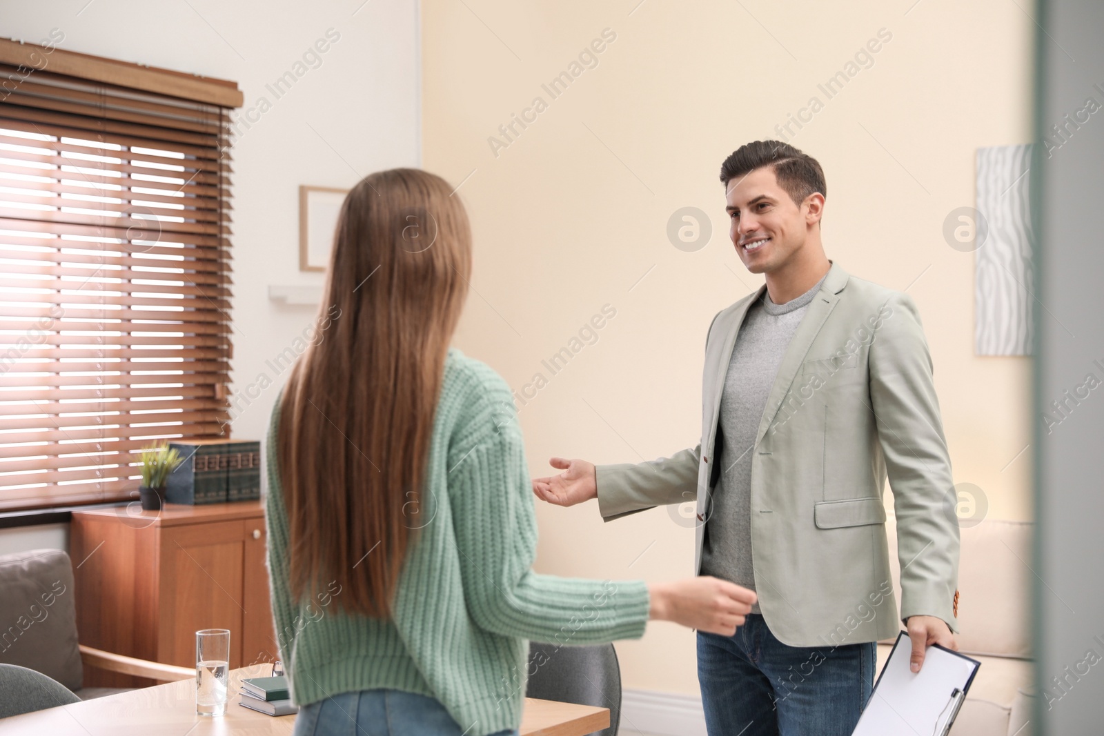 Photo of Professional psychotherapist with young woman in office