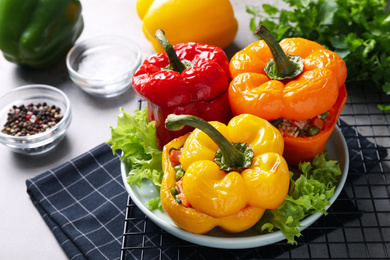 Photo of Tasty stuffed bell peppers on grey table