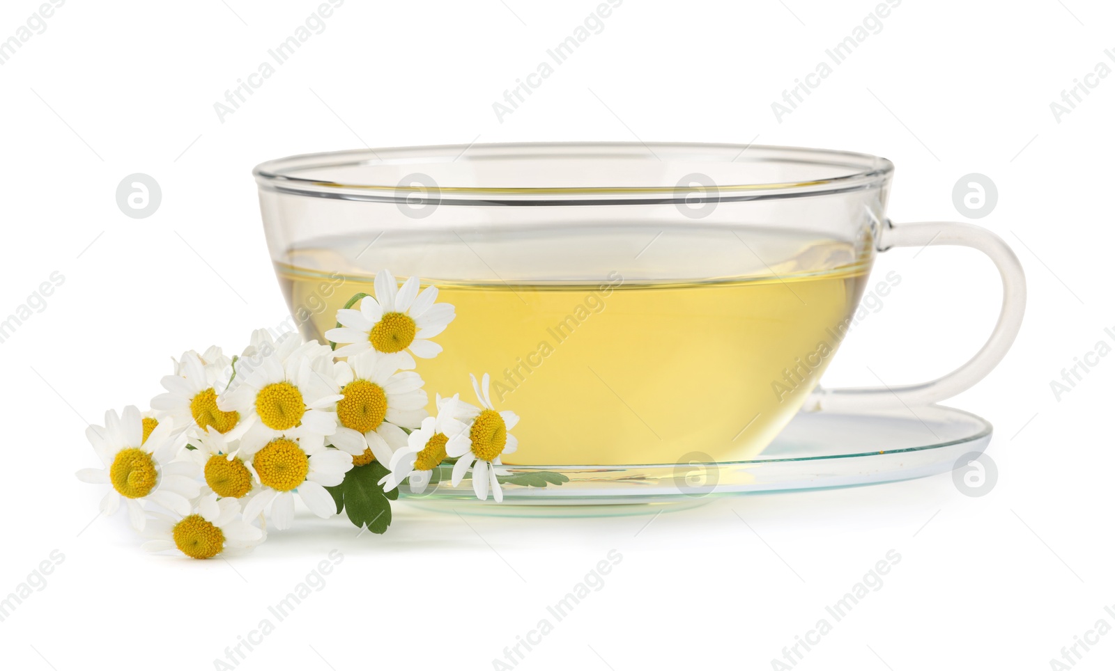 Photo of Aromatic herbal tea in glass cup and chamomiles isolated on white