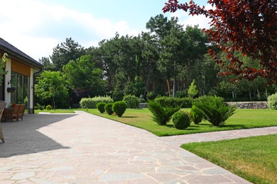 Photo of Landscape with beautiful garden near modern house on sunny day