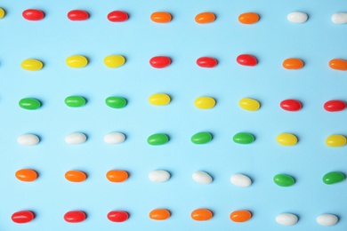 Photo of Flat lay composition with jelly beans on color background