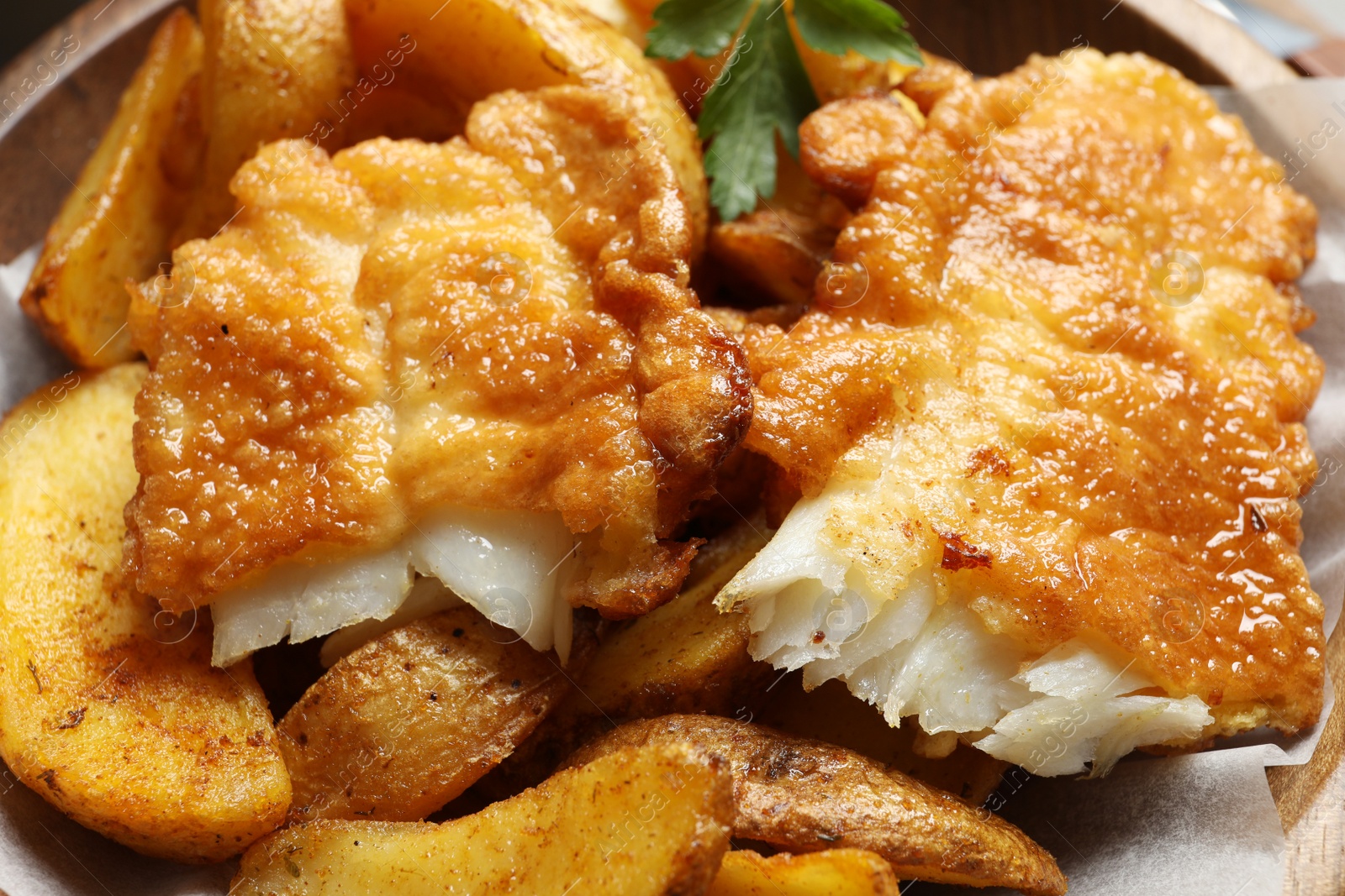 Photo of British traditional fish and potato chips, closeup