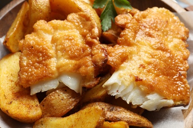 Photo of British traditional fish and potato chips, closeup