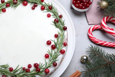 Flat lay composition with traditional Christmas cake on light grey table