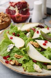 Photo of Delicious pear salad on grey table, closeup