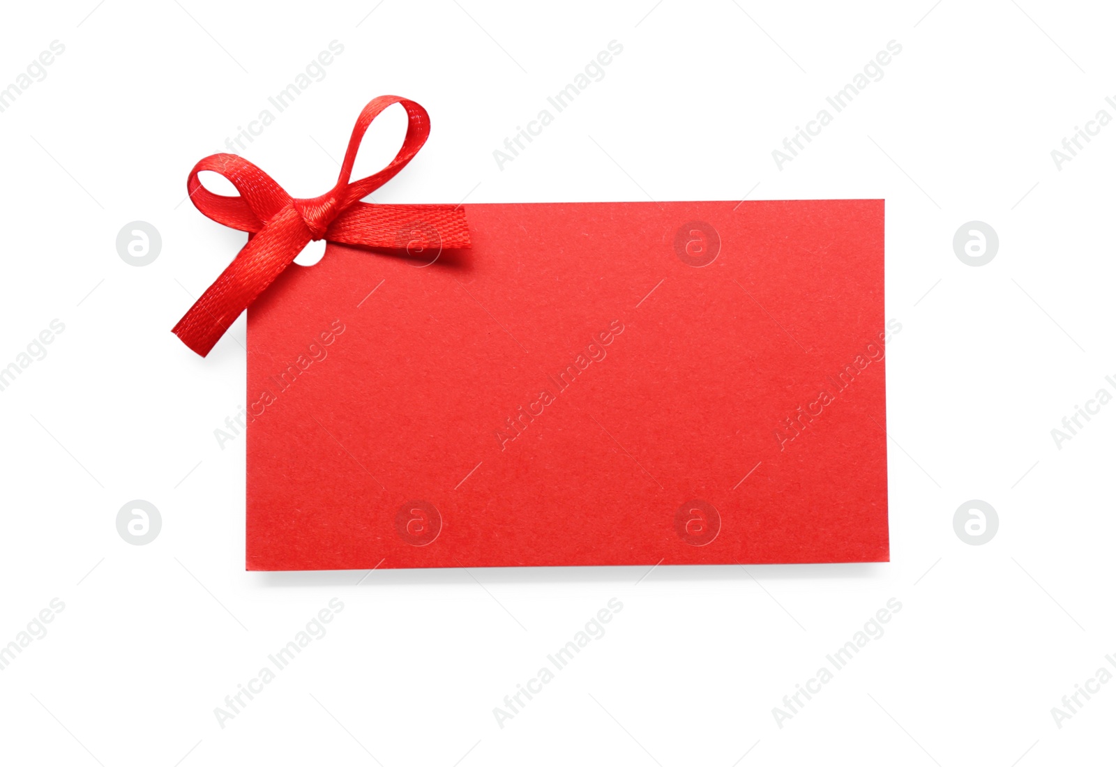 Photo of Blank red gift tag with satin ribbon on white background, top view