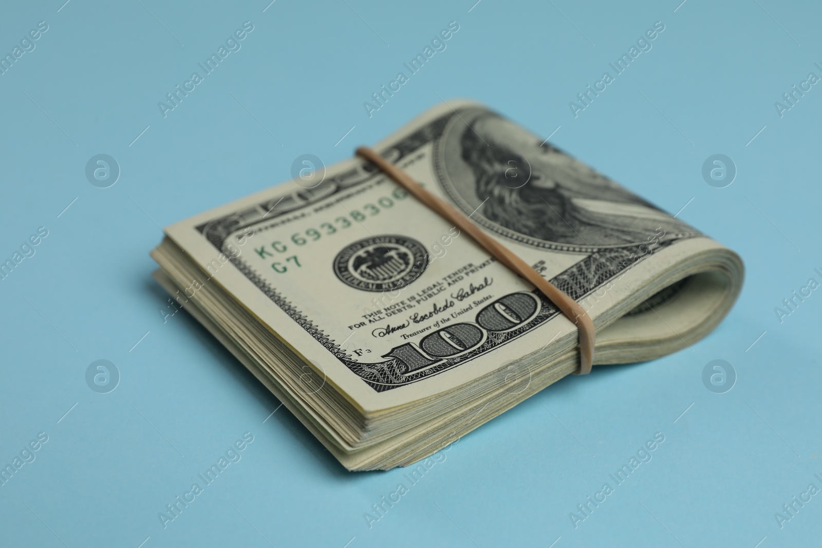 Photo of Money exchange. Dollar banknotes on light blue background