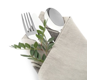 Folded napkin with fork, spoon and knife on white background