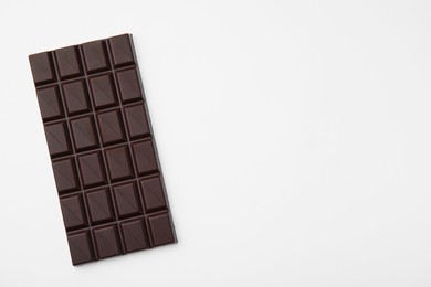 Photo of Tasty chocolate bar on white background, top view