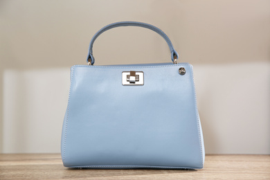 Photo of Light blue woman's bag on wooden shelf