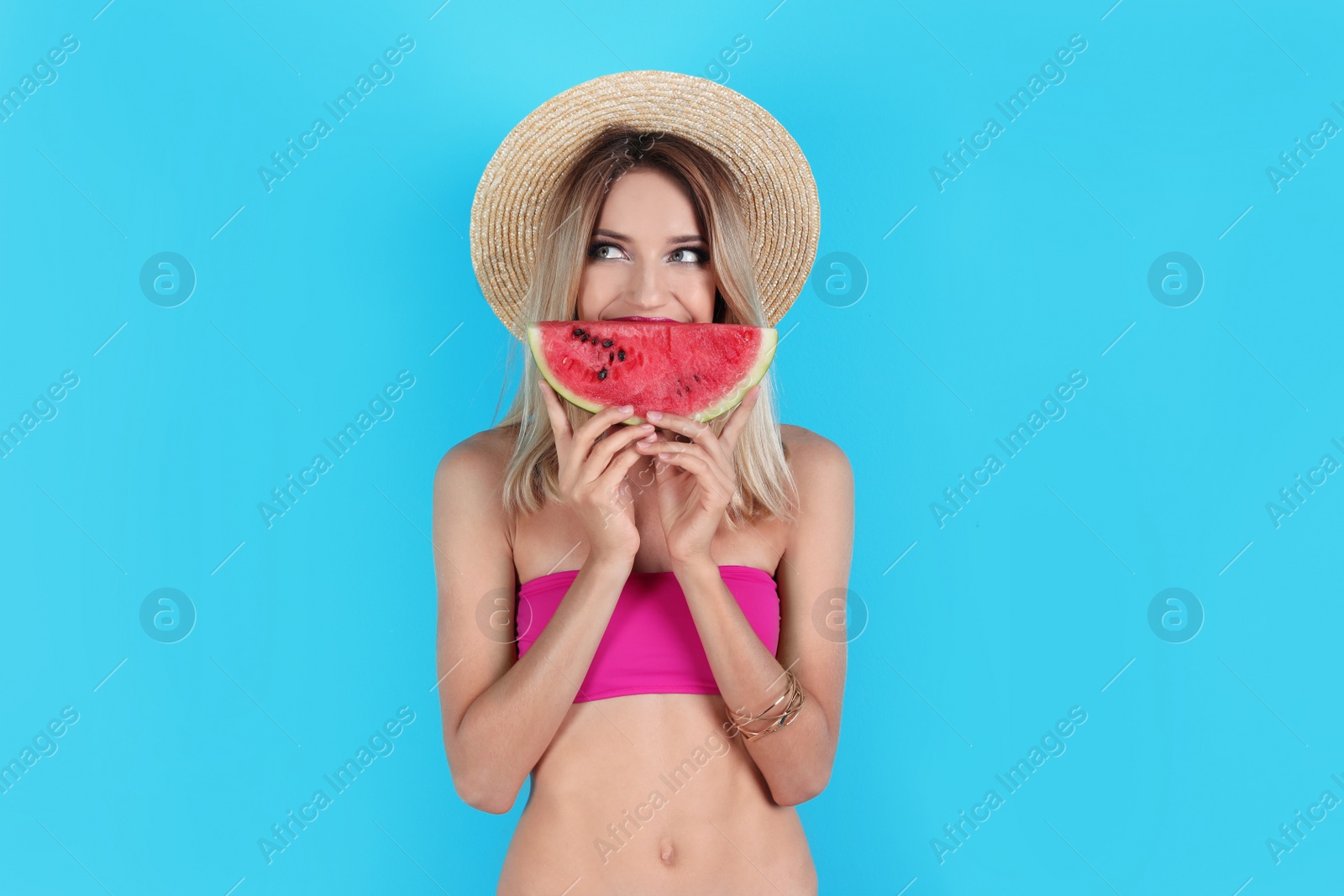 Photo of Pretty young woman with juicy watermelon on color background