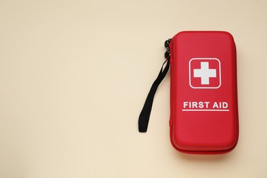 Medicine bag on beige background, top view with space for text. First aid kit