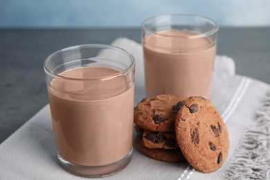 Photo of Glasses with tasty chocolate milk on table. Dairy drink