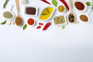 Composition with different aromatic spices and space for text on white background, top view