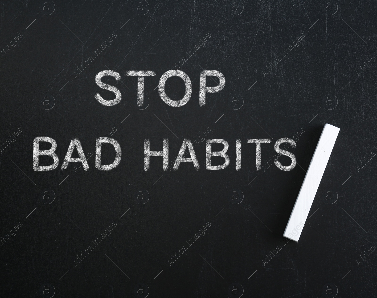Image of Phrase Stop Bad Habits and piece of chalk on blackboard, top view