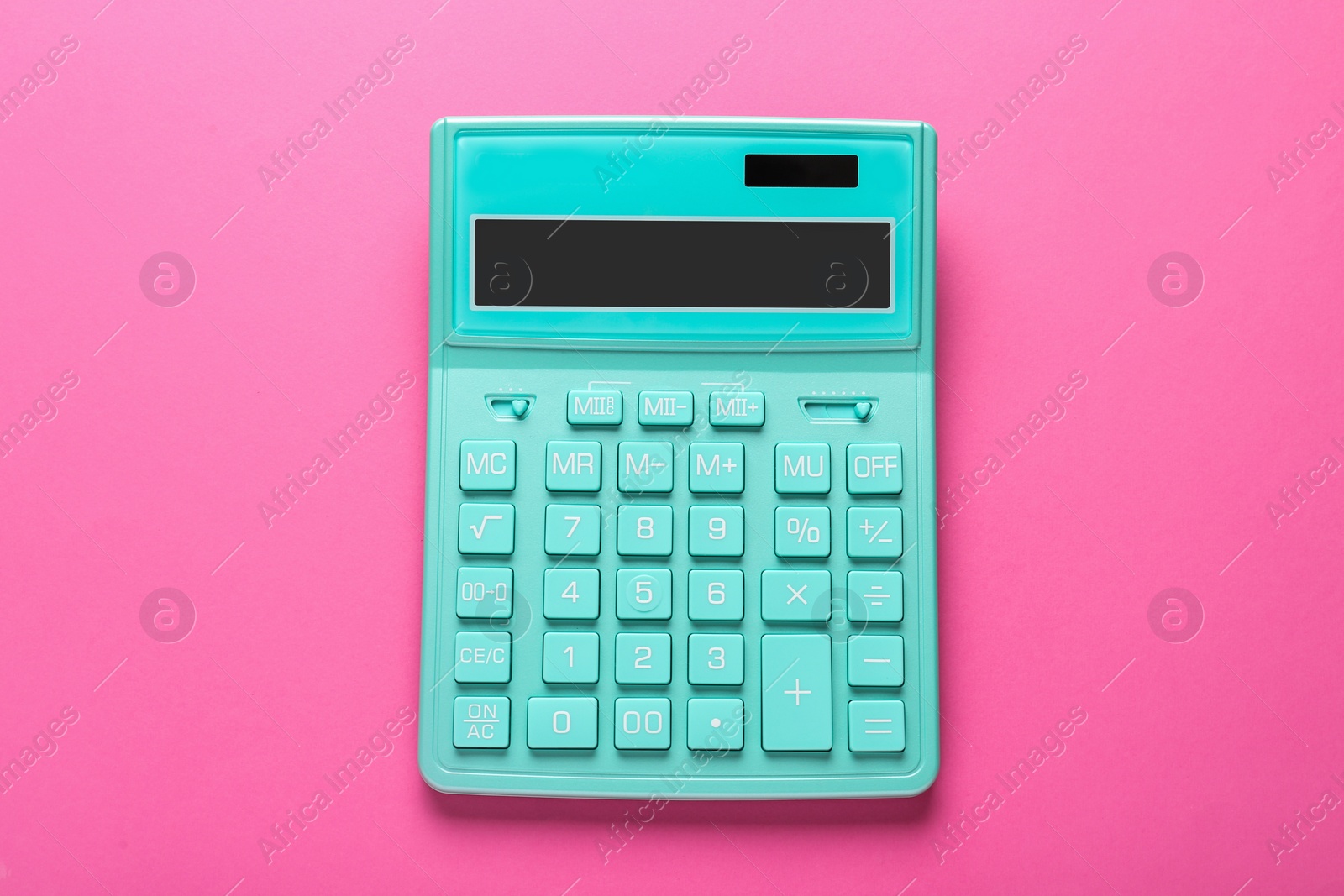 Photo of Turquoise calculator on pink background, top view