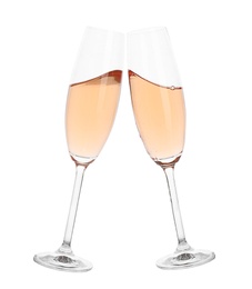 Photo of Toasting with glasses of rose champagne on white background