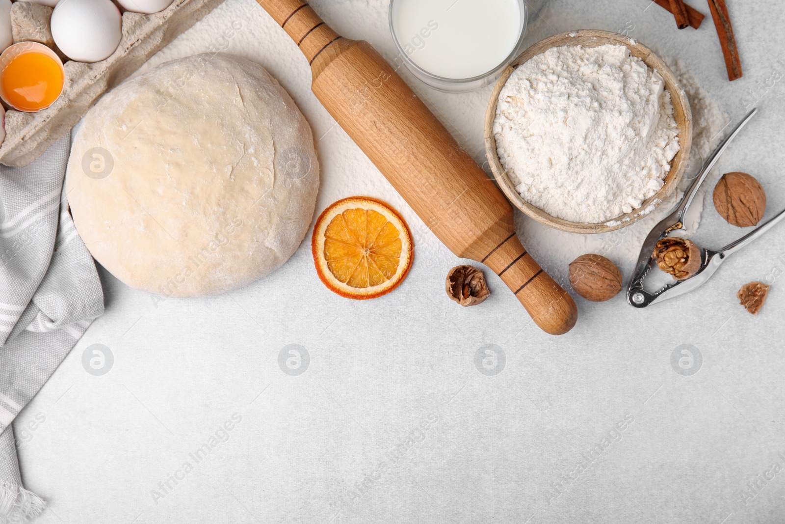 Photo of Flat lay composition with dough and flour on white table. Space for text