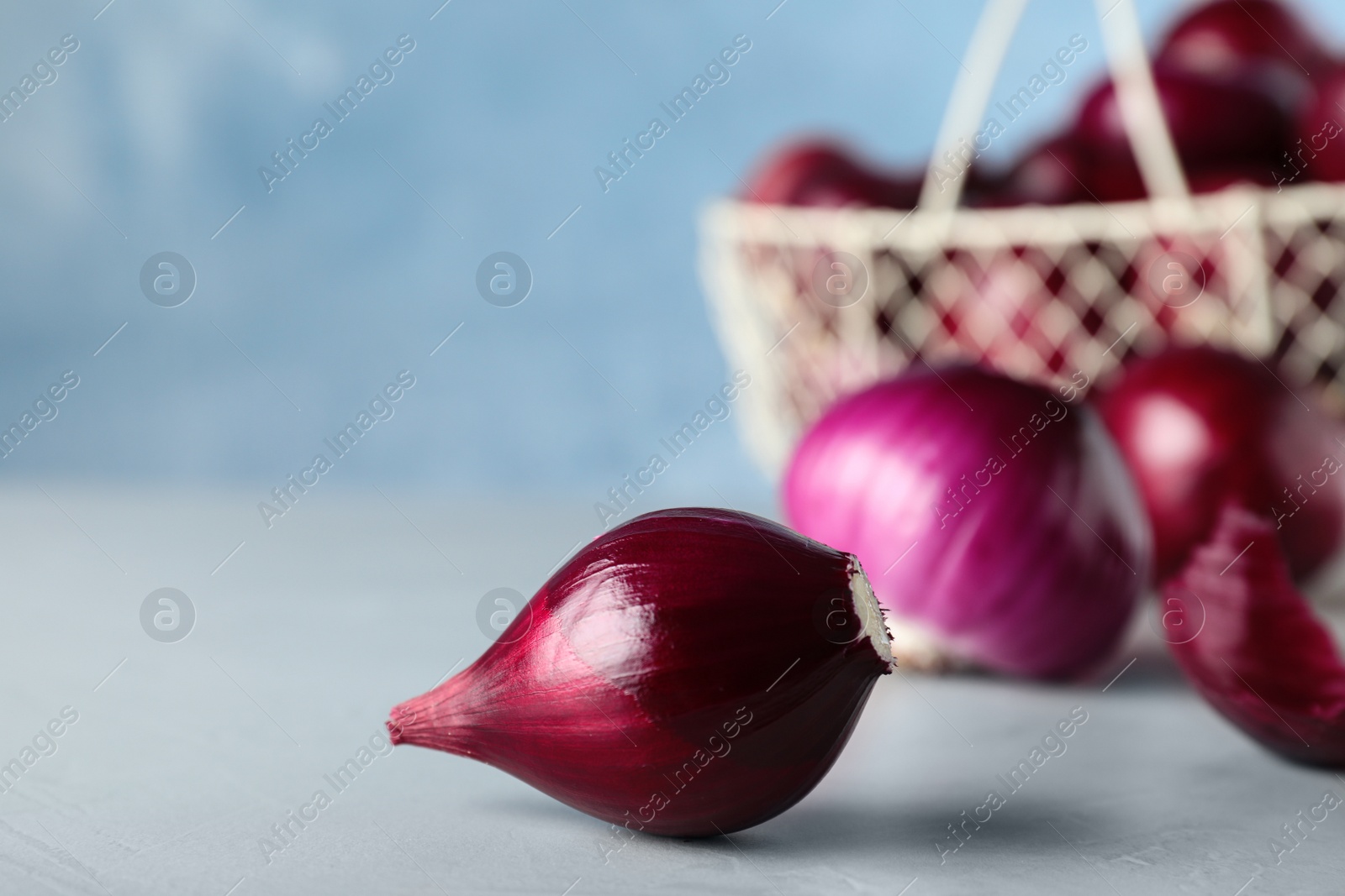 Photo of Fresh ripe red onions on grey table