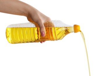 Photo of Woman pouring cooking oil from bottle on white background, closeup