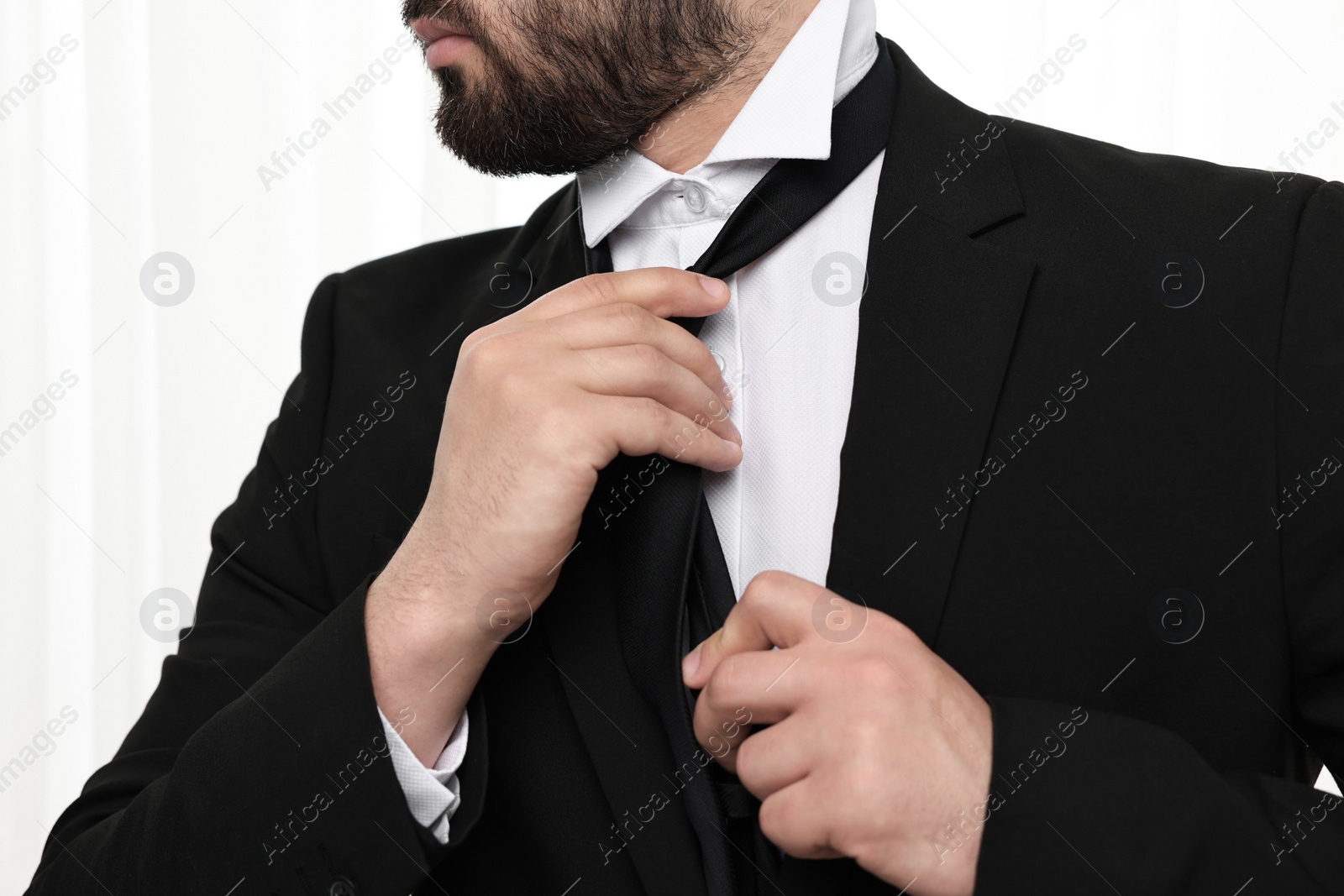 Photo of Businessman in suit and necktie indoors, closeup