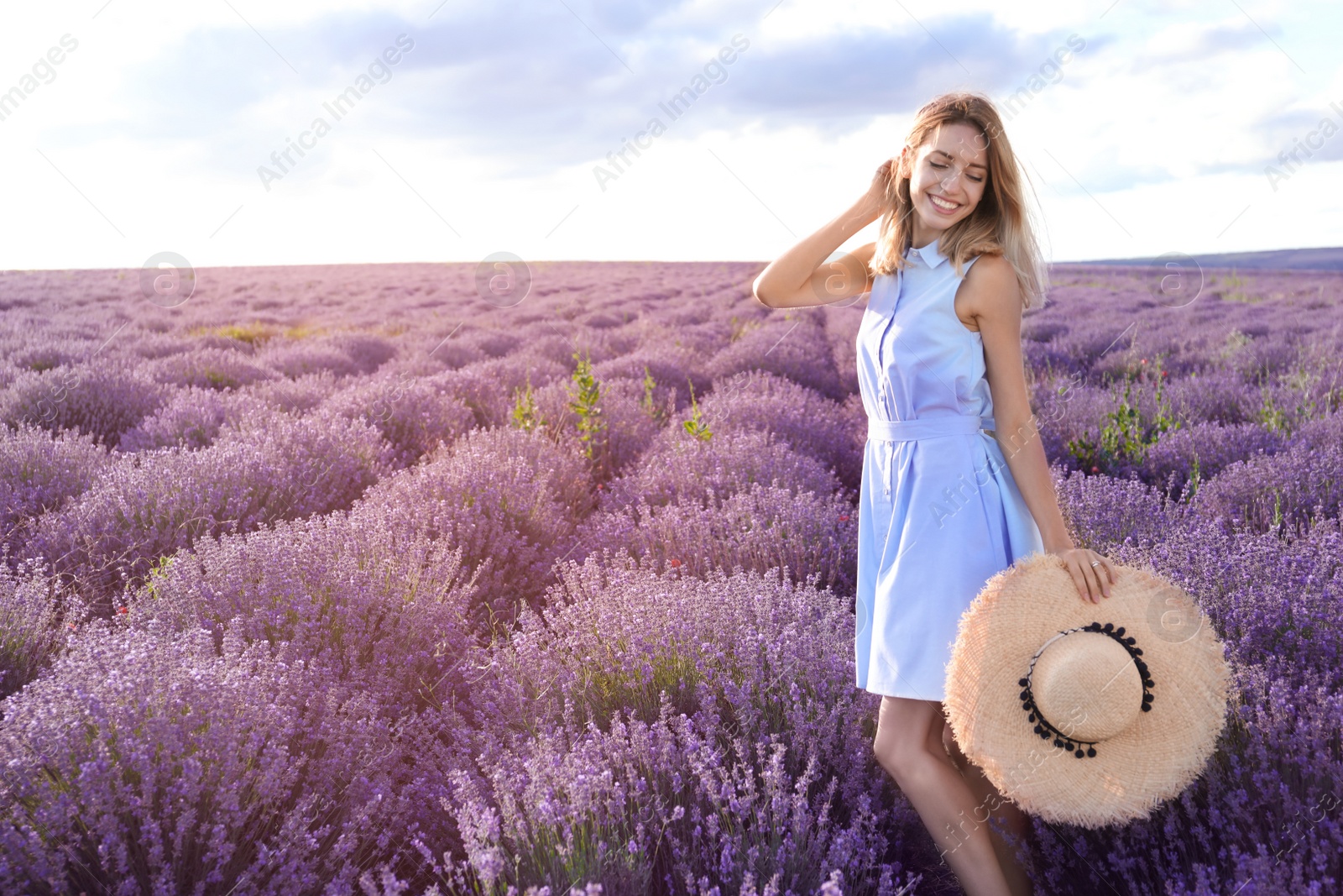 Photo of Young woman in lavender field on summer day