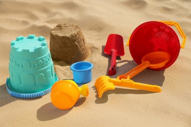 Set of plastic beach toys on sand. Outdoor play