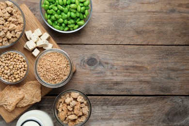 Photo of Different organic soy products on wooden table, flat lay. Space for text