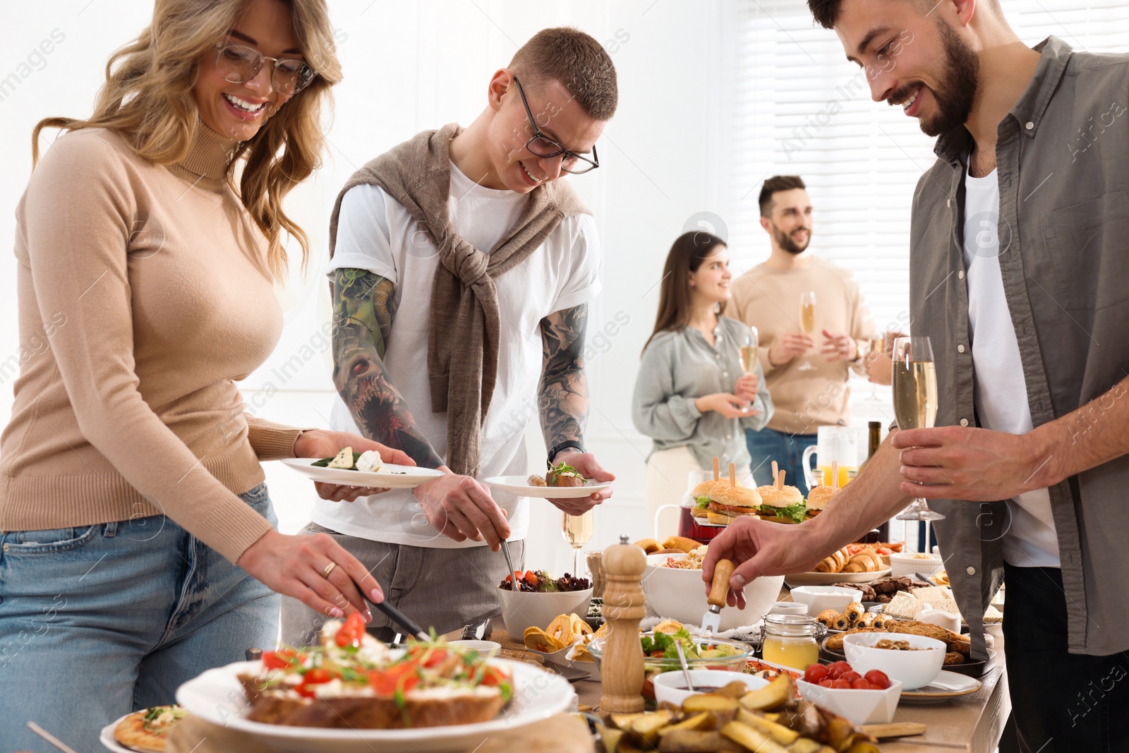 Photo of Group of people enjoying brunch buffet together indoors