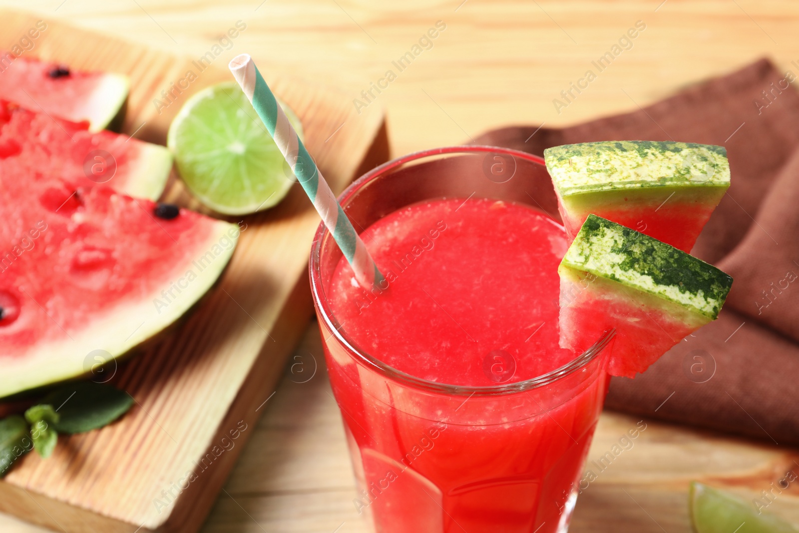 Photo of Summer watermelon drink in glass on table, closeup