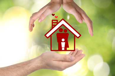 People forming house with their hands and illustration of family on blurred green background, closeup