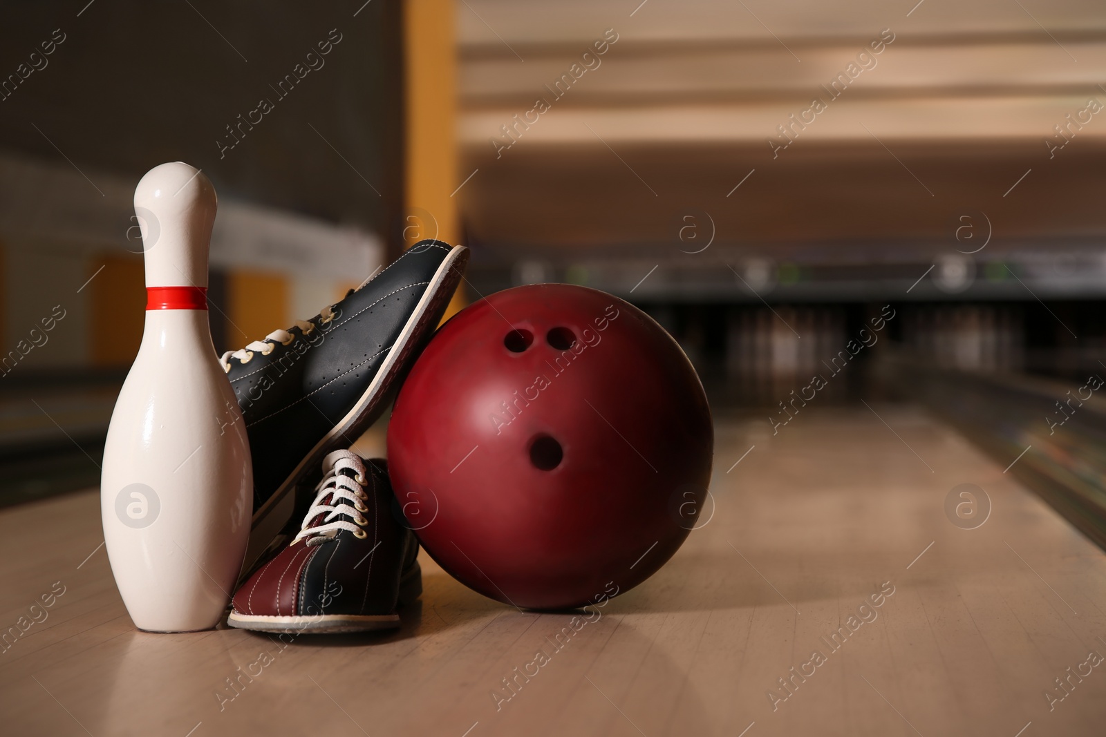 Photo of Pin, shoes and ball on alley in bowling club