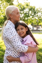 Mature woman with her little granddaughter in park