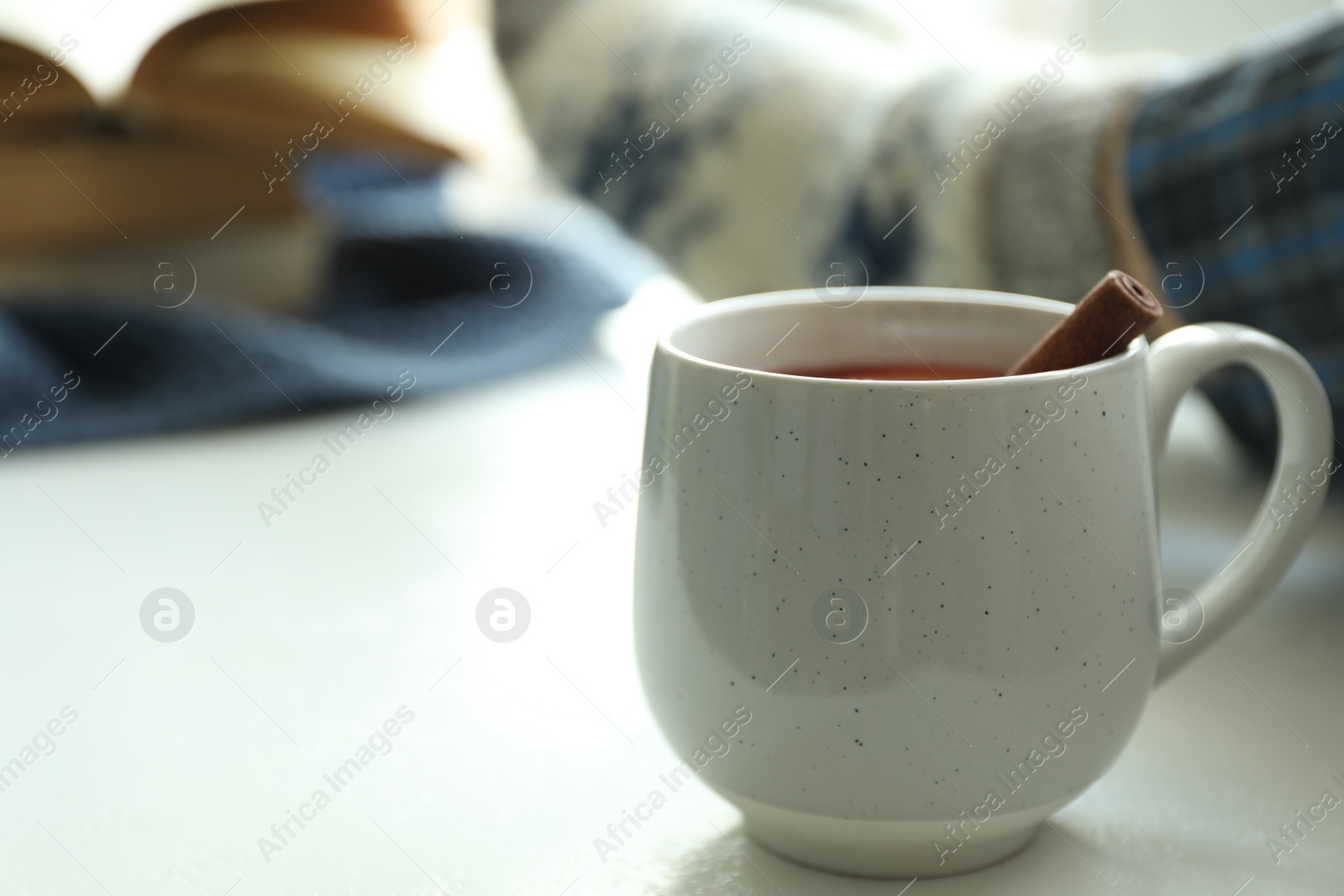 Photo of Cup of delicious mulled wine indoors. Winter drink