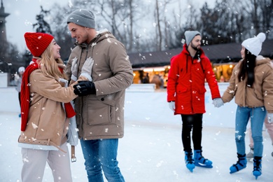Group of friends at outdoor ice skating rink