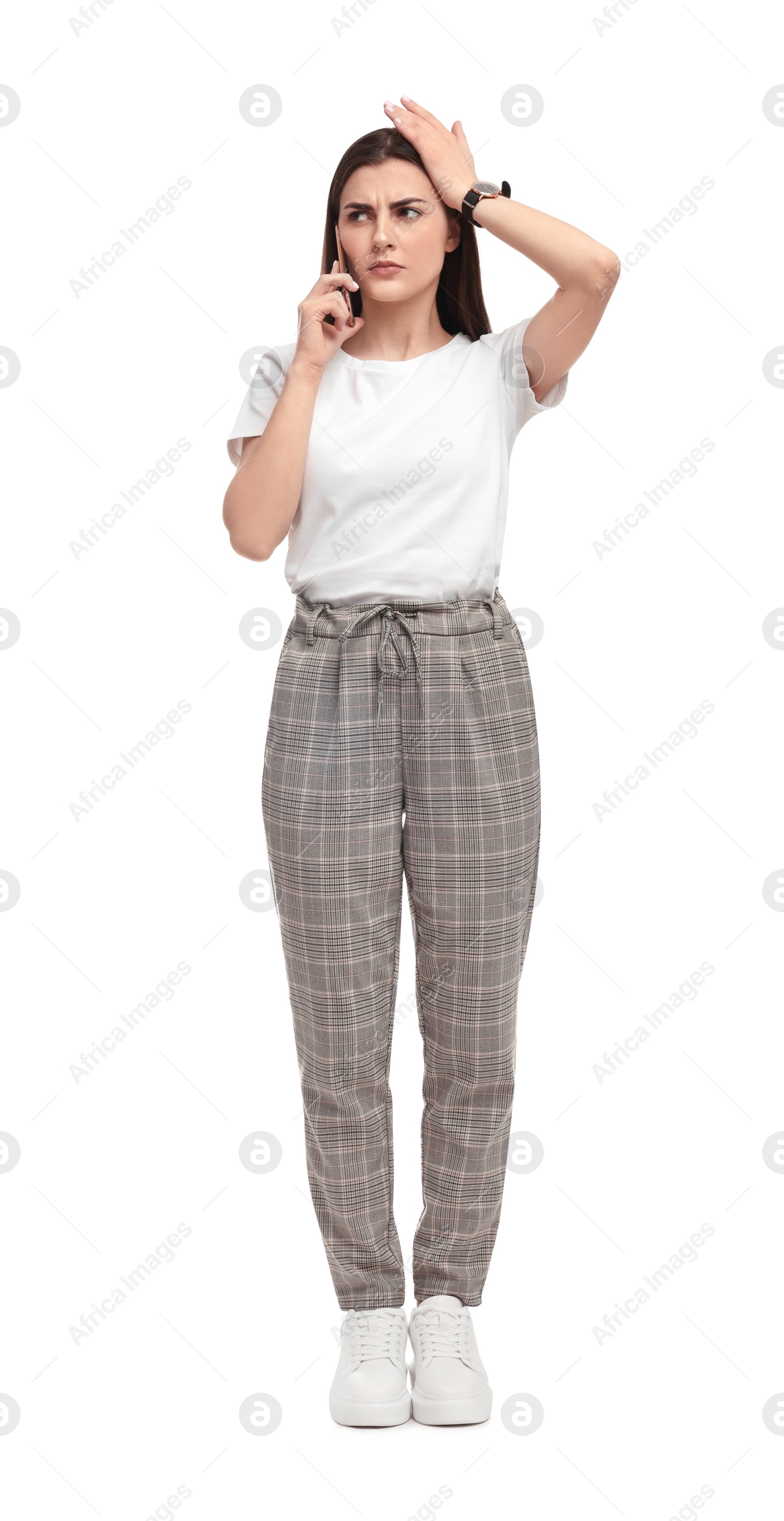 Photo of Beautiful emotional businesswoman talking on smartphone against white background