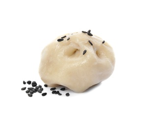 Tasty baozi dumpling with sesame seeds on white background