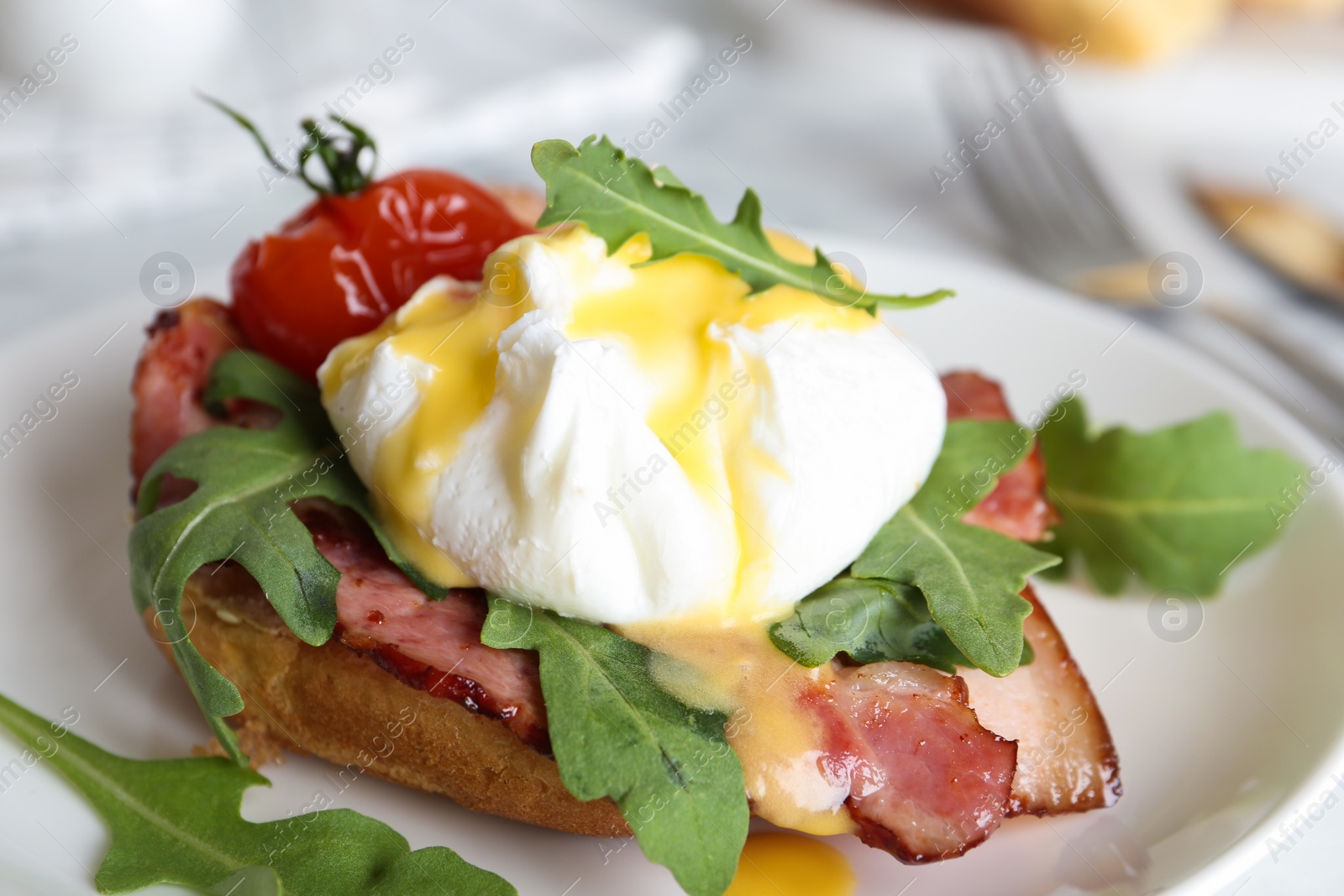 Photo of Delicious egg Benedict served on plate, closeup