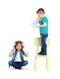 Photo of Adorable little kids with megaphone and headphones on white background