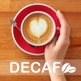 Image of Woman with cup of aromatic decaf coffee at wooden table, top view