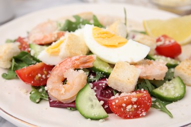 Photo of Delicious Caesar salad with shrimps on plate, closeup