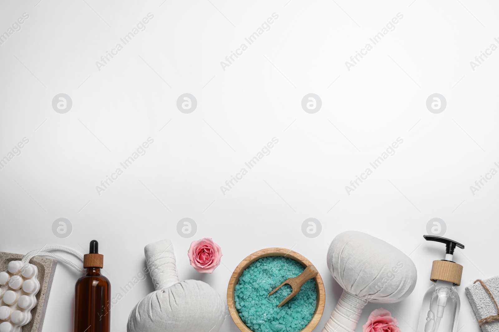 Photo of Beautiful spa composition with herbal massage bags and different care products on white background, flat lay. Space for text