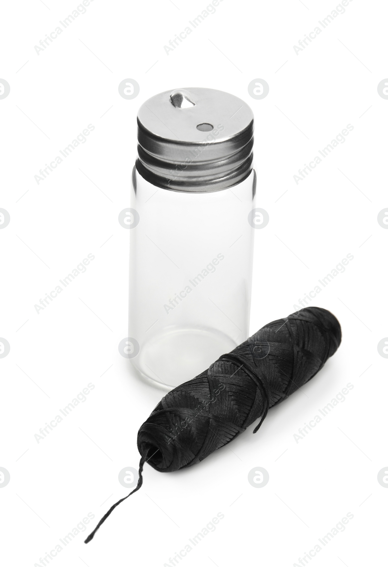 Photo of Roll of natural dental floss and jar on white background