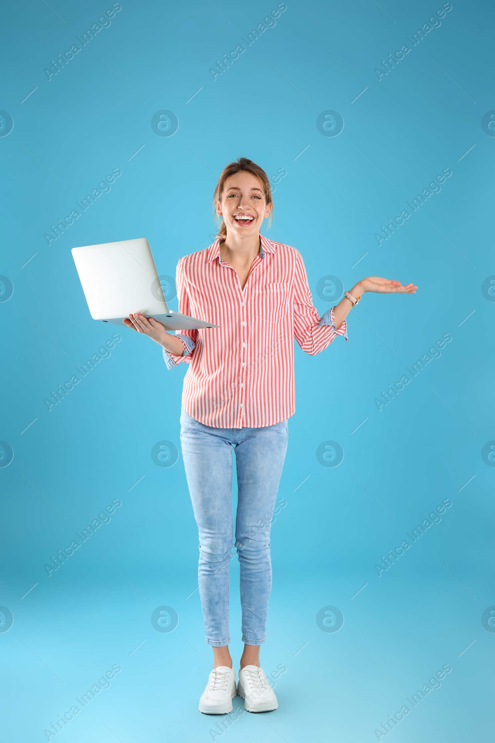 Photo of Full length portrait of young woman in casual outfit with laptop on color background